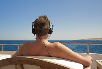 Person relaxing on a boat with headphones