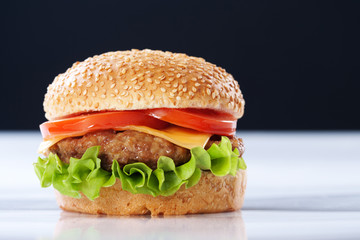 Cheeseburger with tomatoes and lettuce