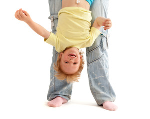 Mother hold her smiling son upside down