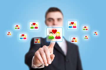 Businessman hand pressing Social network icon 2