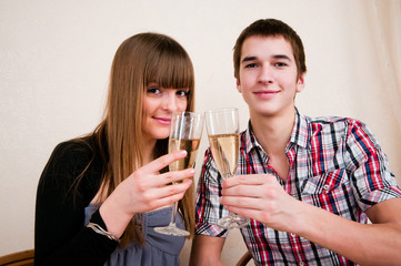 Young, attractive, happy, smiling couple celebrating with champa