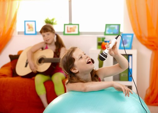 Young girl singing into microphone