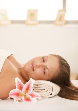 Closeup of beautiful woman sleeping on massage bed