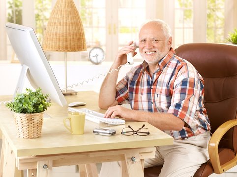 Happy old man on landline call