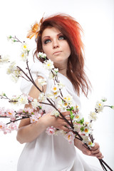 Obraz na płótnie Canvas Portrait of beautiful woman with spring flowers on white