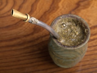 Yerba mate in wooden cup with bombila