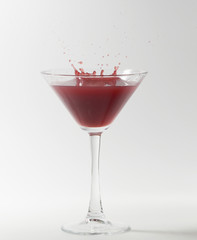 red martini cocktail splashing
