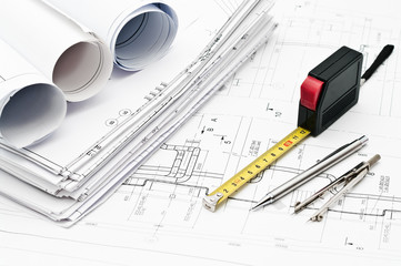 Project blueprints, rule, pencil and compasses on paper