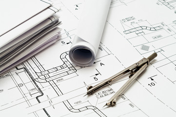 Project blueprints and compasses on paper