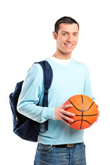 A young adult with school bag holding a basketball