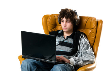 teen boy working on a laptop computer