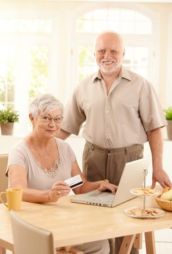 Senior couple purchasing on Internet