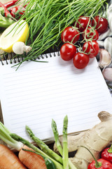 Obraz na płótnie Canvas Open notebook and fresh vegetables