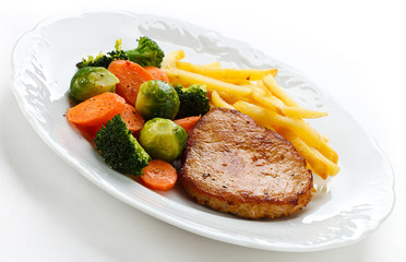 Pork chop, French fries and vegetables