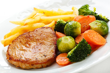 Pork chop, French fries and vegetables