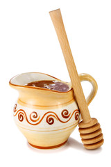 honey in a jug and wooden stick