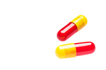 Two Bicolor capsules over white