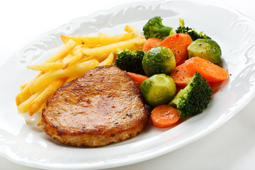 Pork chop, French fries and vegetables