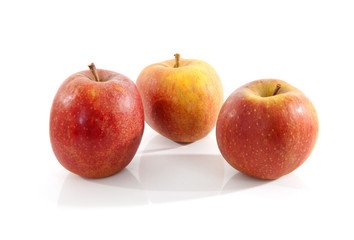 three red apples over white background over white background