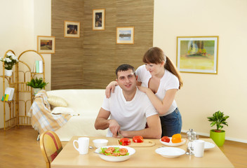 Obraz na płótnie Canvas husband and wife at home in the kitchen