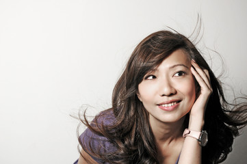 Beautiful Chinese Asian model posing with purple shirt