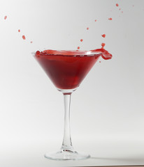 red martini cocktail splashing