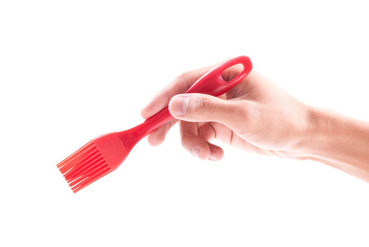 Hand Holding a Cooking Sauce Brush