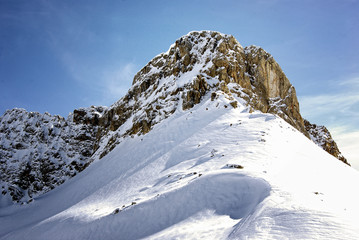 Mountain peak with snow and blue sky