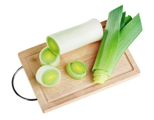 Cross-section of green leek on wooden chopping board