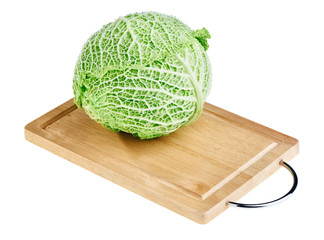 Fresh green cabbage head on wooden chopping board