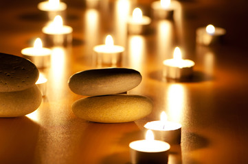 Burning candles and pebbles for aromatherapy session