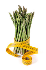 A bundle of green asparagus with measuring tape - 30723988