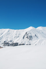 Fototapeta na wymiar High mountains under snow in the winter