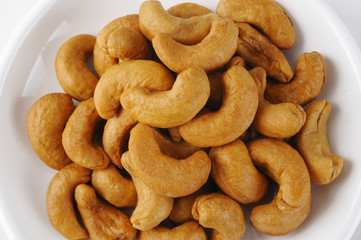 closeup cashew nuts on white dish