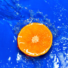 Fresh orange in streaming water