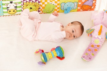 Baby girl looking at colorful toy