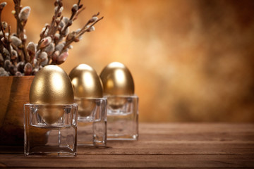 Easter - Golden eggs on brown background