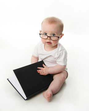 Baby reading wearing glasses
