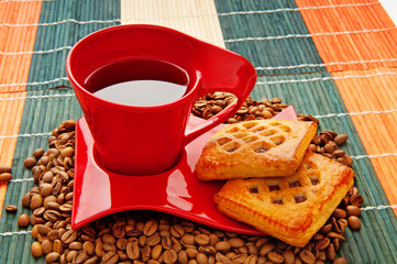 Cup of coffee with many beans around