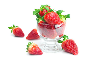 big juicy red ripe strawberries in a glass bowl isolated on whit