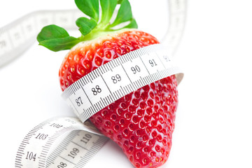 big juicy red ripe strawberries and measure tape isolated on whi