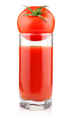 Glass of tomato juice and fruit with green leaves isolated
