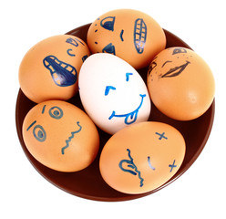 Group of brown and white hen's eggs with different faces in the