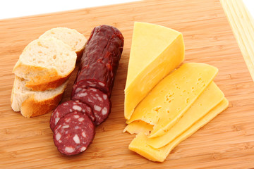 Sausage and bread on wooden surface