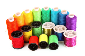 Semicircle of many-coloured bobbins of thread isolated on white