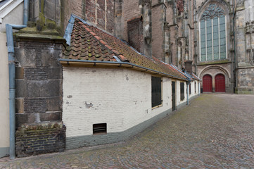 Fototapeta na wymiar small houses against old church