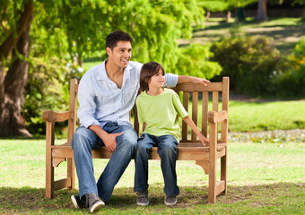 Fototapeta na wymiar Father with his son on the bench