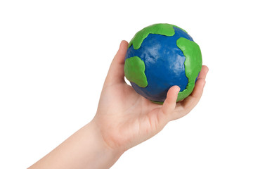 Child's hand holding a globe