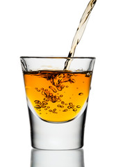 whiskey being poured into a glass
