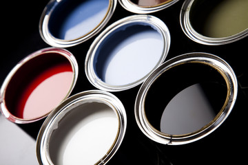 Cans and paint on the colourful background